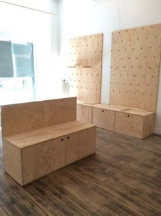 a room with wooden furniture on the floor, and two empty boxes in front of them