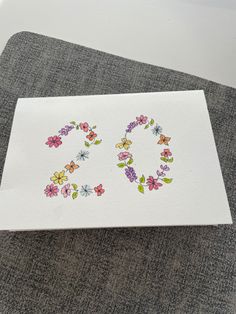 a piece of paper with flowers on it and the word 30 written in floral letters