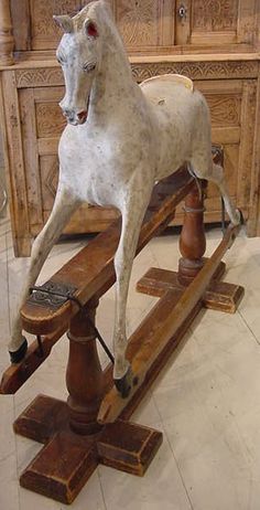 a white horse standing on top of a wooden sled