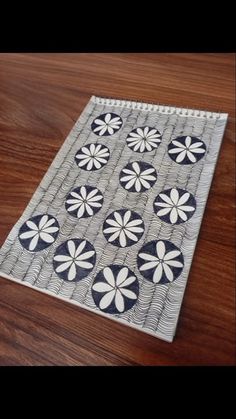 a close up of a piece of cloth on a wooden table with wood flooring