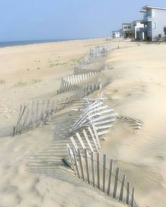 a row of beach chairs sitting on top of a sandy beach