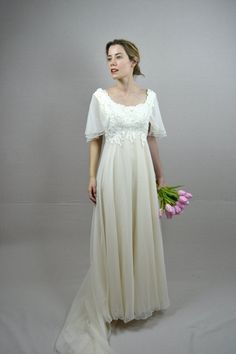 a woman in a white dress holding flowers