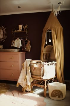 a baby's crib in the corner of a room next to a dresser