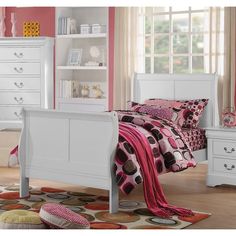 a bedroom with pink walls and white furniture