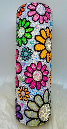 a colorful vase with flowers painted on it