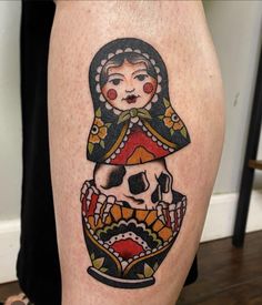 a woman's leg with a tattoo on it that has a skull in the middle