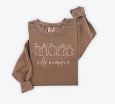 Embrace the cozy vibes of autumn with our 'Hello Pumpkin' Brown Comfort Colors Fall Crewneck. Crafted from premium cotton, this crewneck is your perfect companion for crisp fall days and pumpkin spice moments. Whether you're strolling through autumn foliage or enjoying a warm drink with loved ones, our crewneck offers comfort and style in every season. Key Features: Warm and Cozy: Made from soft Comfort Colors brand crewneck sweatshirts, 80% ring spun USA cotton, 20% polyester Charming Design: F Fall Iron On Designs, Cricut Fall Sweatshirt Ideas, Fall Everyday Cotton Sweatshirt, Fall Cotton Soft-washed Sweatshirt, Soft-washed Cotton Sweatshirt For Fall, Brown Graphic Print Sweatshirt For Fall, Fall Loungewear Sweatshirt, Cozy Brown Sweatshirt For Fall, Soft-washed Sweatshirt For Everyday Fall Wear