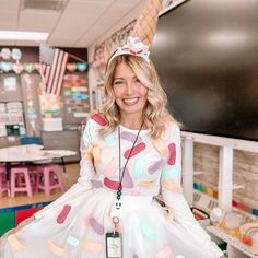 a woman in a white dress is posing with an ice cream cone on her head