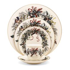 christmas dinnerware set with holly wreath design on the front and side, white background