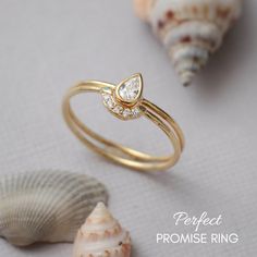 a close up of a ring on a table with shells