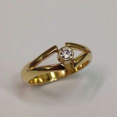 a gold ring with a diamond in the middle