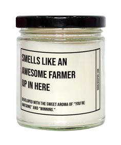 a jar of white candles that says smells like an awesome farmer up in here