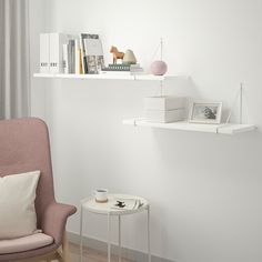 two shelves on the wall above a chair and table