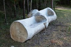 a large log sitting in the middle of a forest