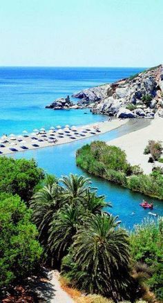 the beach is surrounded by palm trees and blue water