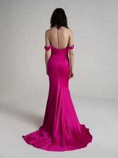 a woman in a long pink dress looking back