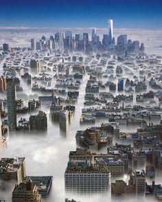 an aerial view of a city in the clouds