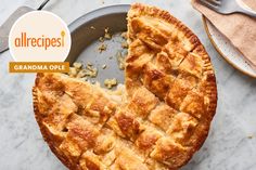 an allrecipes grandma apple pie on a plate with a slice cut out