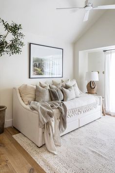 a living room filled with furniture and pillows