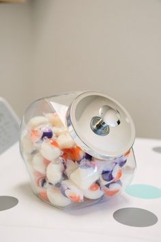 a jar filled with candy sitting on top of a table