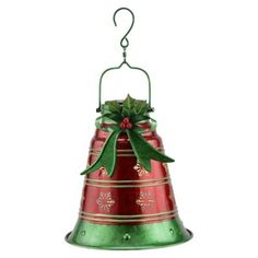 a red and green bell with a bow on it's top hanging from a hook