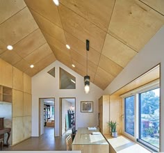 the interior of a modern house with wood paneling and glass windows on both sides