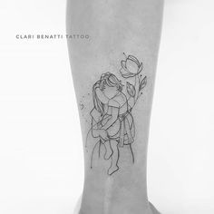 a black and white photo of a woman's foot with a flower tattoo on it