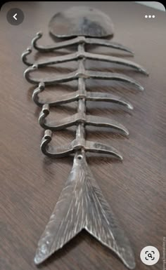 a row of spoons sitting on top of a wooden table