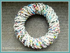 a close up of a wreath made out of newspaper strips