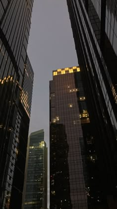 some very tall buildings in the city at night