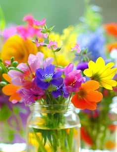 colorful flowers in a glass jar on a table