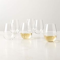 six wine glasses with white wine in them