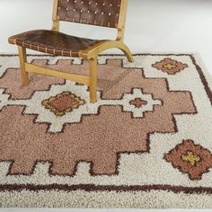 a wooden chair sitting on top of a rug