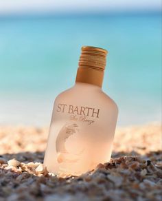 a bottle of st bart on the beach