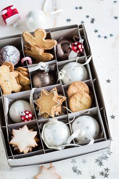 a box filled with lots of different types of cookies and other decorations on top of a table