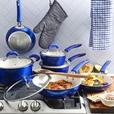 blue pots and pans are sitting on the stove