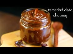 a jar of date chutney on a cutting board