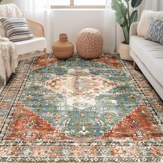 a living room area with couches and rugs