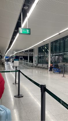 an airport terminal with luggage on the ground and people waiting for their bags to be picked up