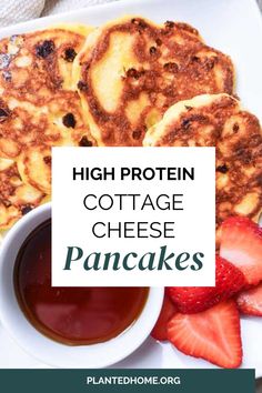 high protein cottage cheese pancakes on a plate with strawberries and syrup in a bowl