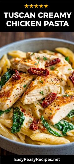 chicken pasta with spinach and sun dried tomatoes in a white bowl