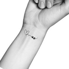 a woman's arm with a small tattoo on it that says i love you