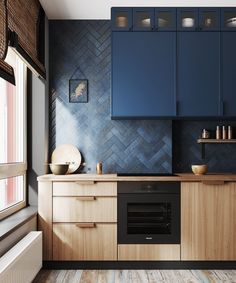 a kitchen with blue cabinets and wood floors