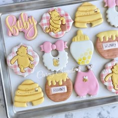 baby shower cookies are arranged on a cookie sheet