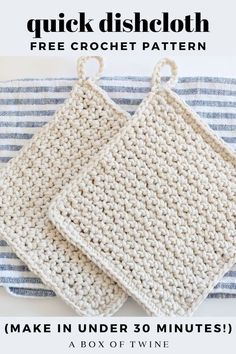 two crocheted dishcloths sitting on top of a blue and white towel