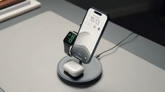 an apple watch and cell phone charging on a dock with the charger plugged in