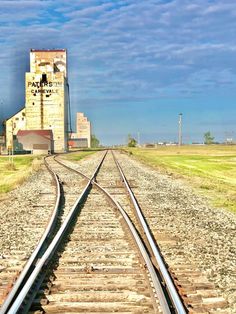 the train tracks lead to an old grain silo