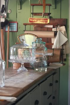 an old fashioned kitchen counter with glassware on it