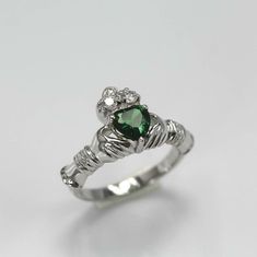 1.01ct Lab-Created Green Emerald Ring Moissanite Claddagh White Gold Plated Note: 1. If you are ordering a ring, kindly confirm your ring size within 24 hours of purchase for speedy process of manufacturing or a standard size will be sent. 2. Box shown in image may differ as per availability. 3. Ct. wt. mentioned is approx weight and may vary ( high/low) post manufacturing. 4. Pendant may or may not come with a chain. Please check the title accordingly or contact us. Shipping Policy: 1. Manufact Irish Rings, Green Emerald Ring, Irish Traditions, Shipping Services, Green Emerald, Emerald Ring, Emerald Green, Wedding Rings Engagement, Wedding Engagement