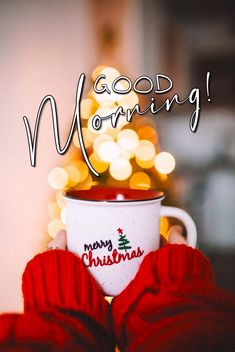 someone holding a coffee cup with the words good morning in front of a christmas tree